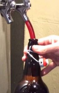 A growler being filled from the tap by the foot long hose