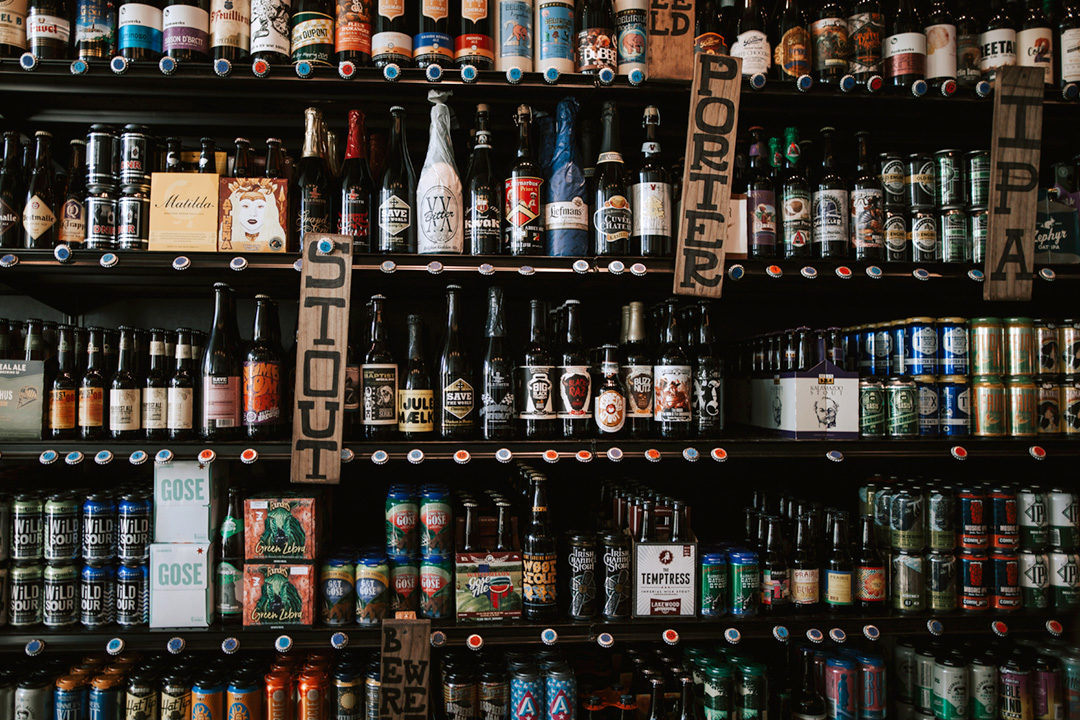 A stocked beer shelf featuring a bunch of different styles