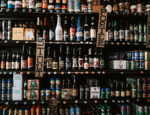 A stocked beer shelf featuring a bunch of different styles